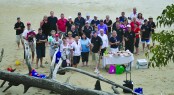 A toast to good weather and smooth cruising as the Riv team enjoys lunch on the beach