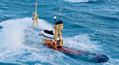 Oceanic Tug in heavy weather before conversion by Icon Yachts