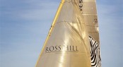 Line Honours Winner INVESTEC LOYAL crossing the finish line Photo K. Arrigo