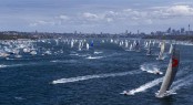 Sailing yacht Wild Oats XI leads fleet out of harbour after start of 68th Rolex Sydney Hobart