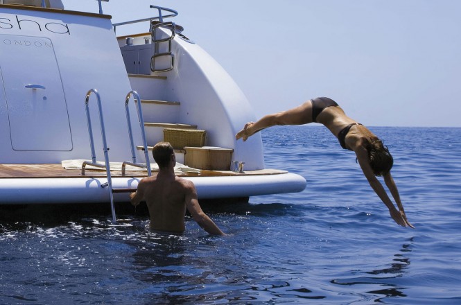 A superyacht charter diving in from the aft deck