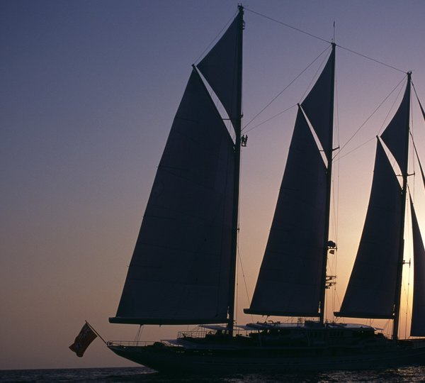 90m Royal Huisman sailing mega yacht at sunset