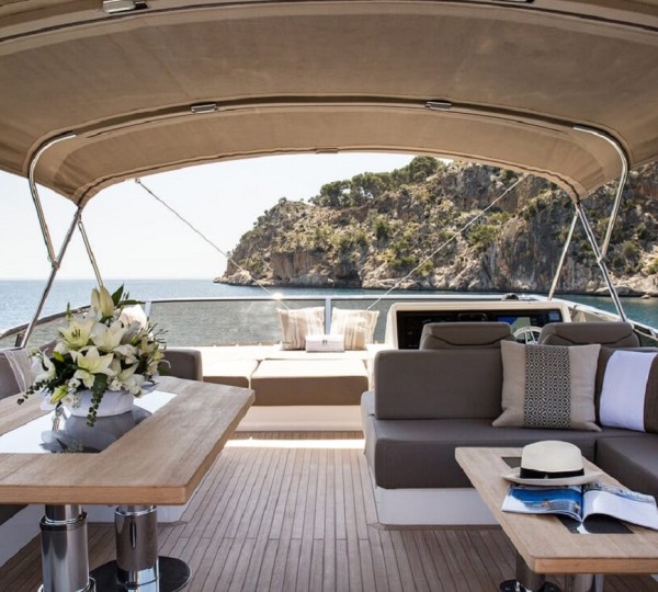 Bimini covered flybridge lounge and dining