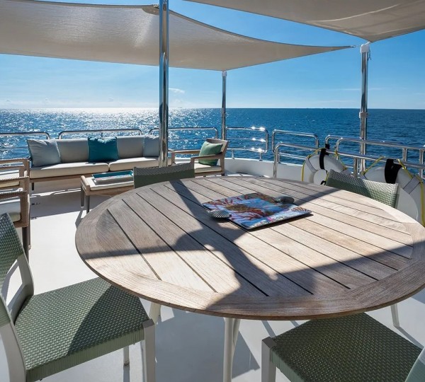 Fly bridge dining under soft bimini