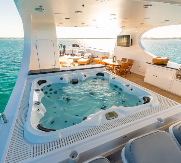 Sundeck with grill, jacuzzi, dining and gym