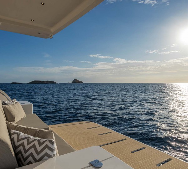 Aft facing sofa over central swim platform