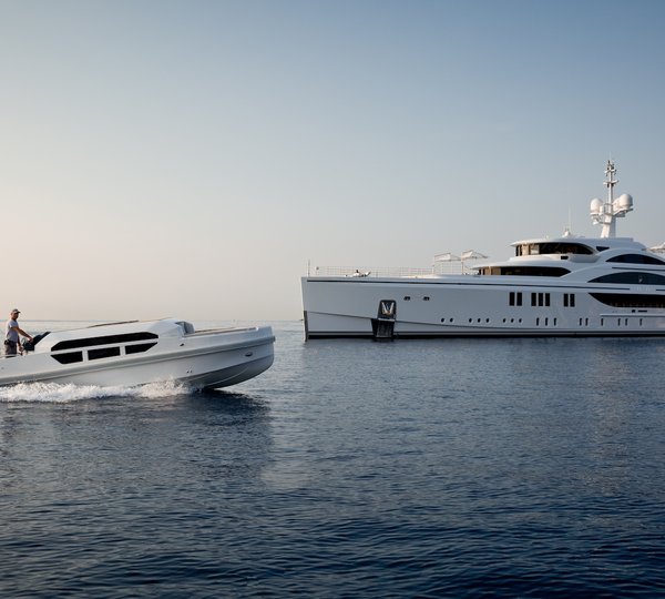profile of the yacht with tender