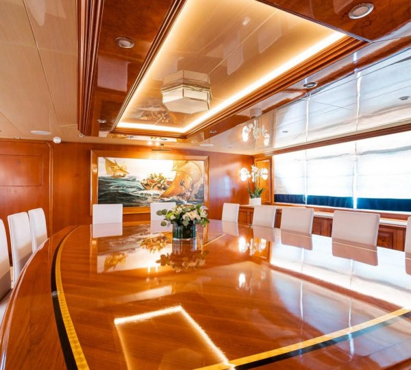 A Room With A Large Table And Chairs Aboard_