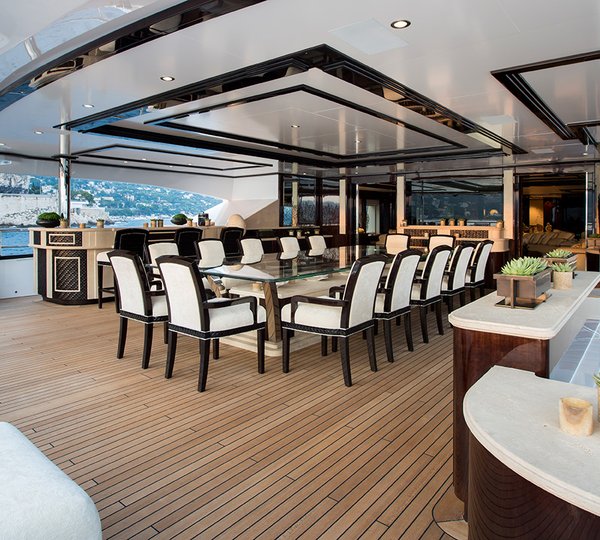 Alfresco Upper Deck Dining Area With A Huge Table And Elegant Seating
