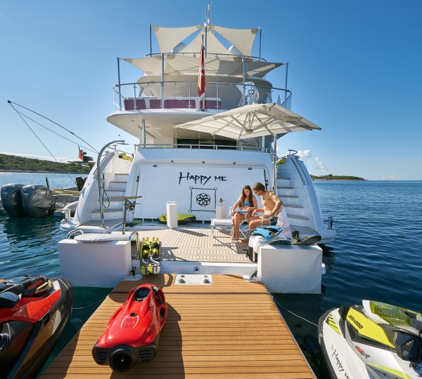 Couple On The Yacht's Swim Platform And Toys