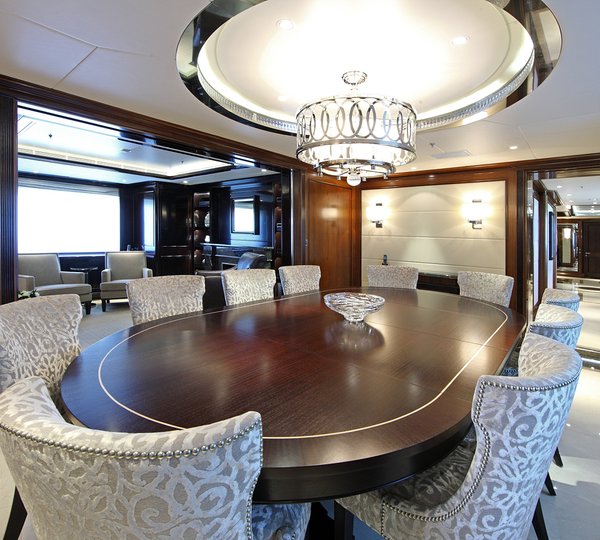 Elegant Dining Area With Large Table And Plush Seating