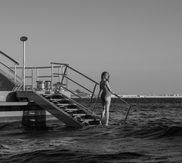 Model Walking Into The Water Off The Yacht