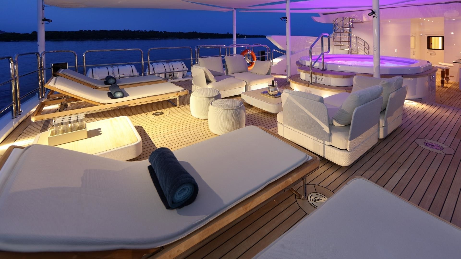 Jacuzzi on the sun deck with sunbeds after sunset
