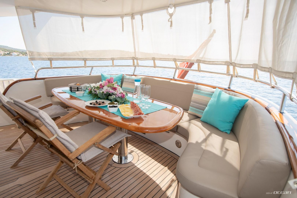 Aft deck dining with sun curtains