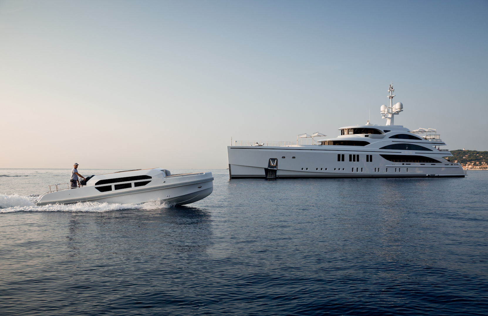 profile of the yacht with tender