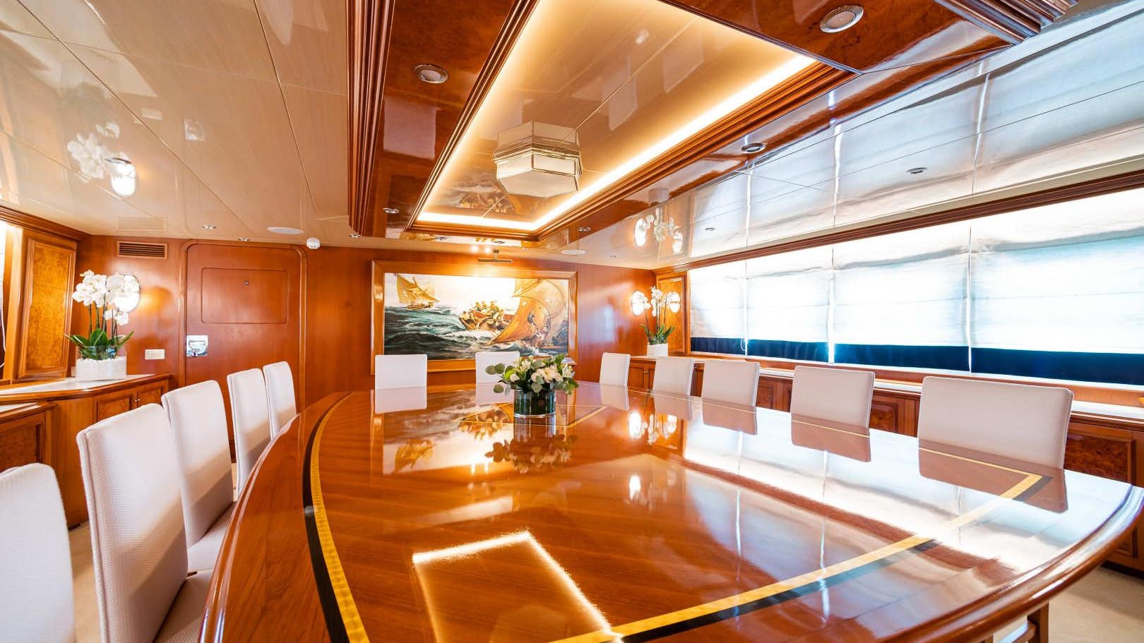 A Room With A Large Table And Chairs Aboard_