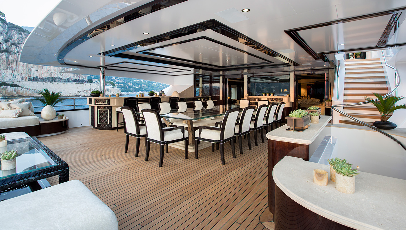 Alfresco Upper Deck Dining Area With A Huge Table And Elegant Seating