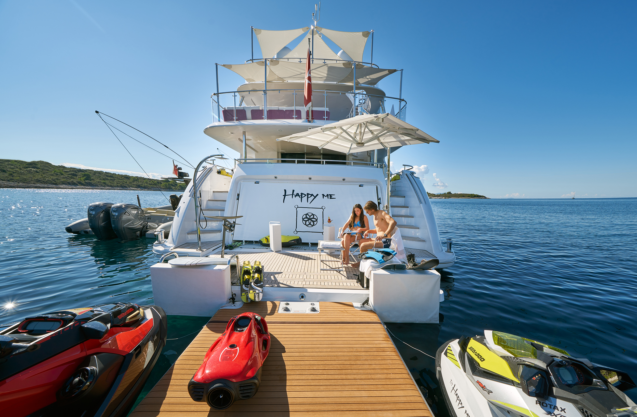 Couple On The Yacht's Swim Platform And Toys