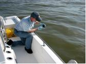 Dr Jeff Short takes an oil sample from the Gulf of Mexico
