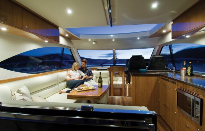 Expansive panoramic windows and huge electric sunroof brings the outdoors in on the Riviera 5000 motor yacht 