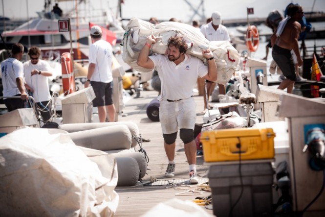 Crews carrying the sails after training - Photo Pedro Martinez - Audi MedCup - Region of Sardinia Trophy 2011