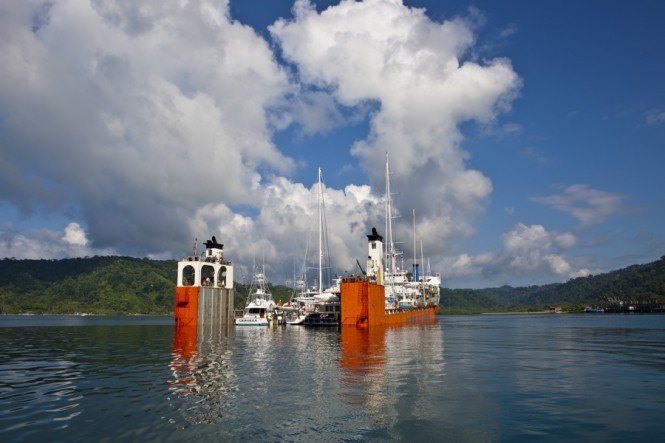 Dockwise Yacht Transport’s (DYT) bright orange semi-submersible ship, Super Servant 4, picks up yachts in Golfito, Costa Rica before heading to Brisbane, Australia. (Photo credit Onne van der Wal)