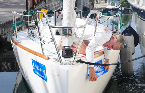 Regatta bow stickers are carefully applied. Ready to race!  Credit: Todd vanSickle/BVI Spring Regatta & Sailing Festival