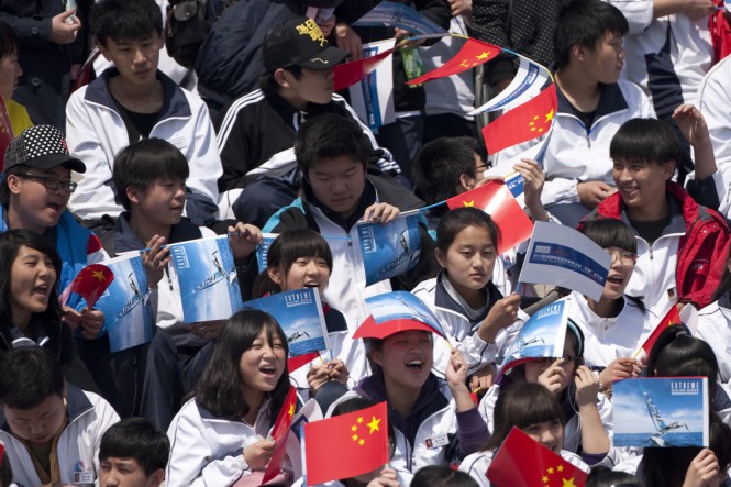 Chinese school children enjoying the racing on the first day in Qingdao