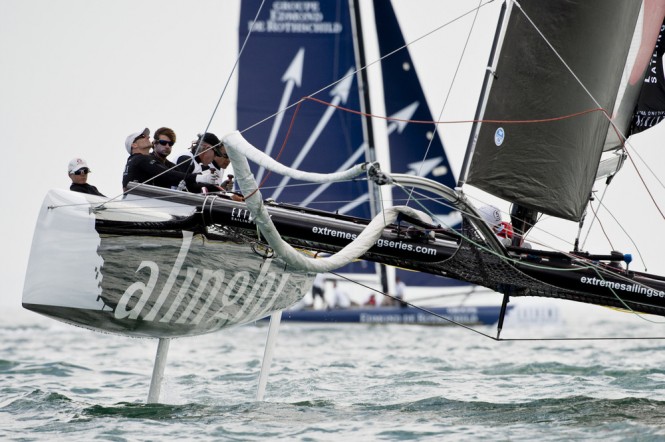 Alinghi flies a hull during racing on Day 1 of Act 3