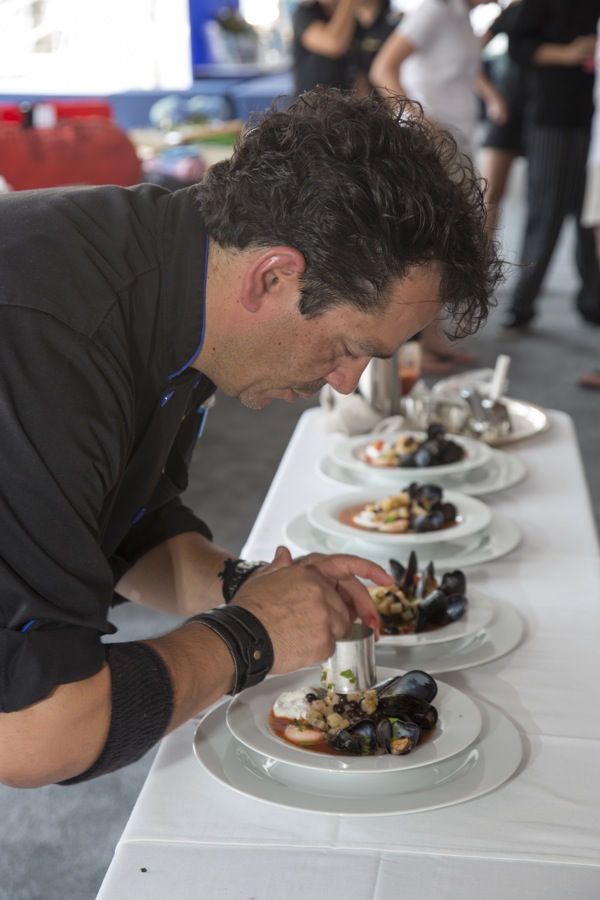 Chef Jean Paul of the 150-foot motor vessel Encore took third place in the Grande Class of the Newport Charter Yacht Show Culinary Competition with his dish that consisted of poached scallops and eggs with steamed mussels (photo credit Billy Black)