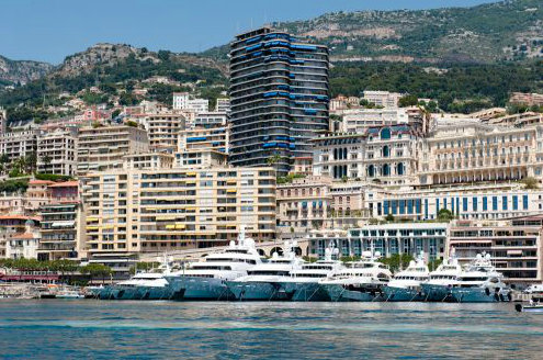 Luxurious yachts lined up along the Quai des États-Unis