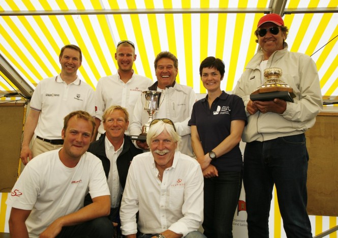 Roger Thompson, J.P. Morgan Asset Management (left) with the winning crew of ‘Manroland Sheetfed’ and Tony Langley holding the Gold Roman Bowl, presented by Dame Ellen MacArthur at today’s prizegiving at the Island Sailing Club in Cowes. Photo: Patrick Eden