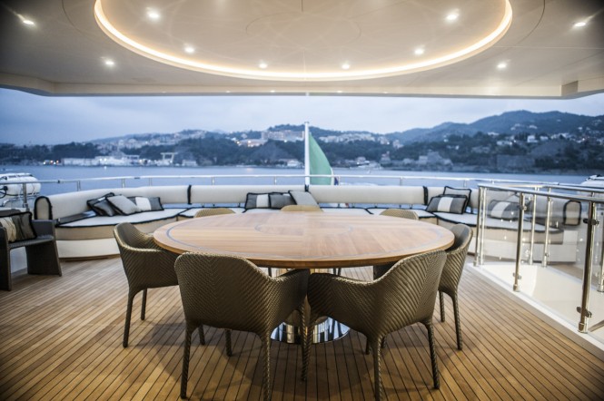 Al fresco dining table and lounging area aboard OKKO yacht  flydeck - Image courtesy of Mondo Marine