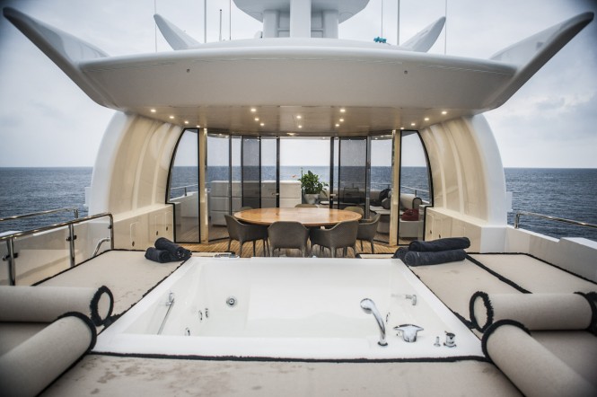 OKKO superyacht - fly deck with spa pool, al fresco dining table and lounging area aft separable by a glass wall - Image courtesy of Mondo Marine
