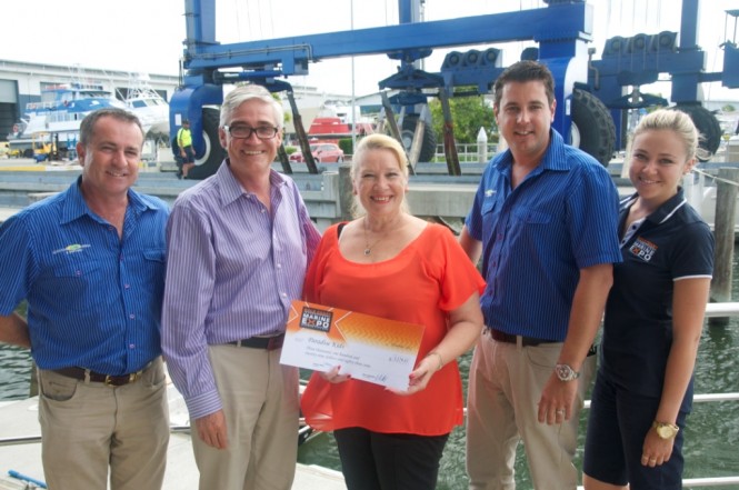 Members of the Expo Association present Mireille Allan from Paradise Kids with their cheque from the 2012 Gold Coast International Marine Expo