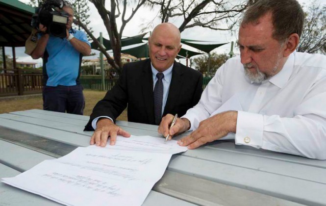 Gold Coast Aboriginal Community Representative Bill James signs a memo of understanding agreement with Sembawang President and CEO Ric Grosvenor. Sembawang is committed to enlisting the support of local traditional land owners.