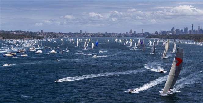 Sailing yacht Wild Oats XI leads fleet out of harbour after start of 68th Rolex Sydney Hobart