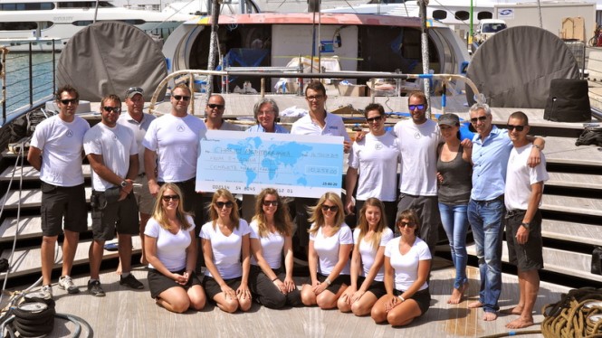 Crew of sailing yacht Aglaia with cheque for 12,258€ for charity 'Mediterranea'