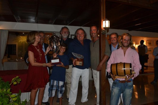 Left to right: Susanna and Enzos Addari, owners of The Inn at English Harbour, Rocco Falcone (son of Carlo) holds The Inn Challenge Trophy, Mauro Pellaschier, skipper of the '83 America's Cup boat Azzurra, Carlo Falcone holds the the exquisite Lalique Victoire figurehead, a keepsake for the first edition of the regatta, Mat Barker owner of The Blue Peter, Gianluca 'Lillo' Mazzetti, Robbie Fabre owner of Vagabundo II with the barrel of English Harbour Antigua Rum, courtesy of Premier Beverages - Credit: The Inn Challenge Trophy © 2013 - J Rainey / tropicalstudios.com