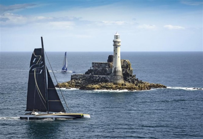Superyacht Spindrift 2 just ahead of Banque Populaire yacht as she passes the Fastnet Rock on Monday afternoon - Photo by Rolex Kurt Arrigo