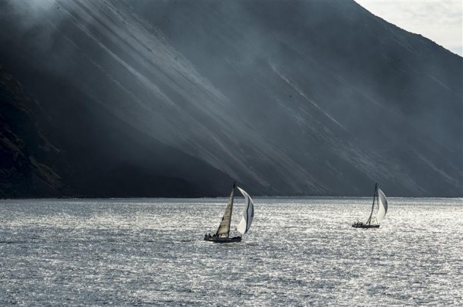 Fleet sailing close to the Stromboli shore - Photo by Rolex Kurt Arrigo