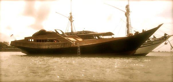 Dragoon 130 yacht next to the original phinisi vessel