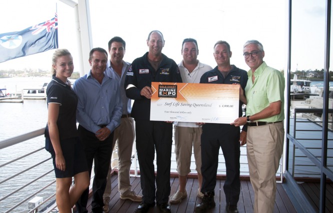 Expo representatives present the cheque to the Westpac Surf Life Saver Helicopter Service