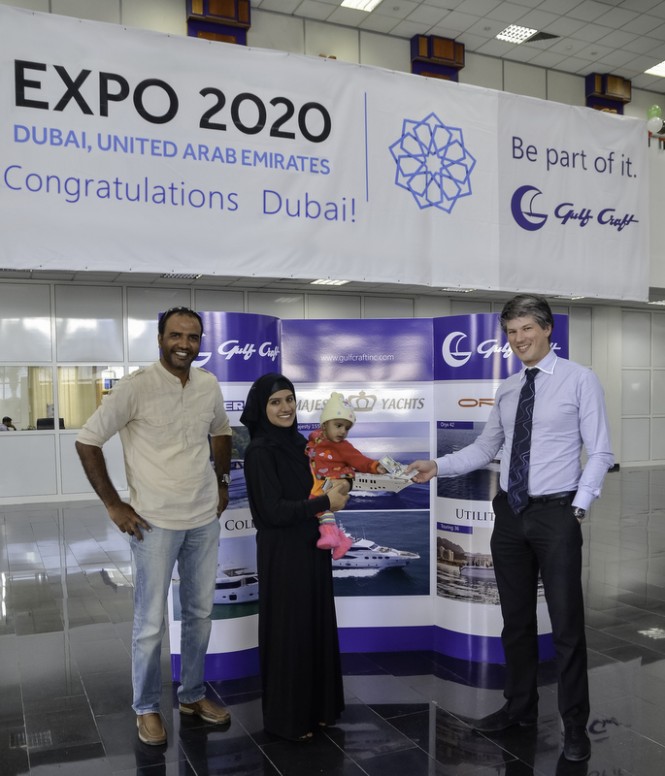 Mr. Erwin Bamps, Chief Operating Officer at Gulf Craft, awards the USD 300 cash prize to Ms. Afshan Rashid from Ajman, UAE - winner of the Gulf Craft's Expo 2020 Like, Share & Win promo
