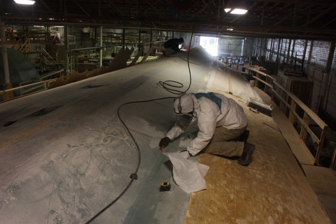 Motor yacht Blank Check - First run of fiberglass going on the bottom