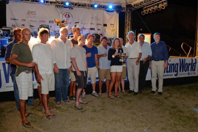 Mike Slade and crew of ICAP Leopard collect the Line Honours Trophy for the Yachting World Round Antigua Race Credit: Ted Martin/Photofantasy