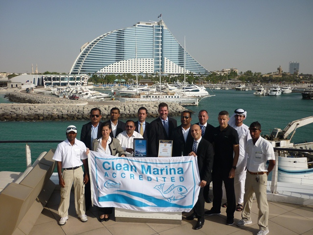 John Hogan Superior (centre) presenting Jumeirah Beach Hotel Marina management  staff with their Clean Marina accreditation