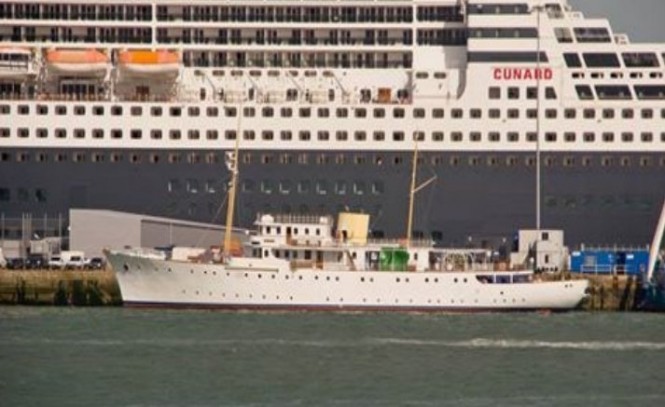 Classic yacht Shemara berthed in Southampton with one of the Cunard’s fleet of cruise liners in the background 