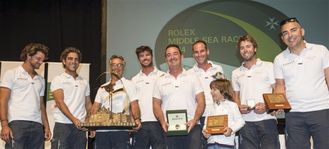 Lee Satariano and crew of ARTIE (MLT) receiving the Rolex Middle Sea Race trophy and Rolex timepiece - Photo by Rolex Kurt Arrigo
