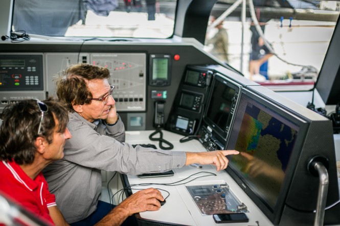 Jean-Paul Riviere and Jacques Delorme on board Finot-Conq 100, Nomad IV, study the weather before the start of the RORC Transatlantic Race - Image by RORC James Mitchell